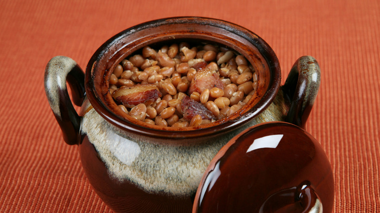 old fashioned baked beans in pot with golden meat pieces