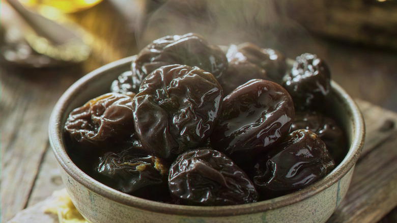 bowl of large stewed prunes