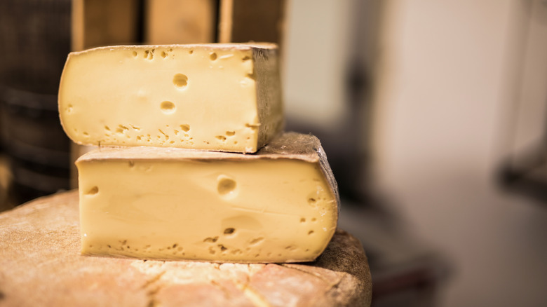 Blocks of French cheese stacked on top of one another