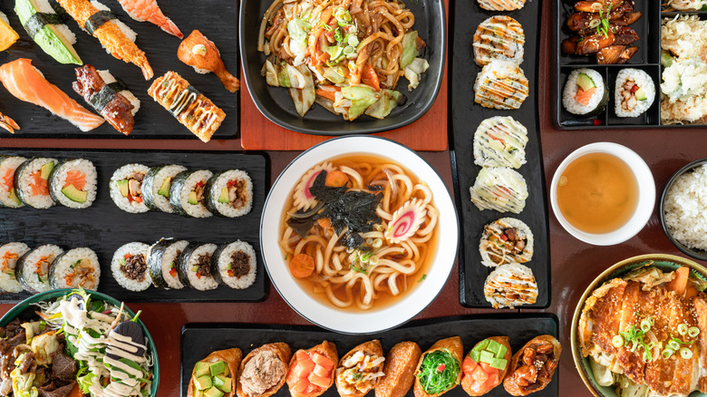 A large variety of Japanese foods on a table