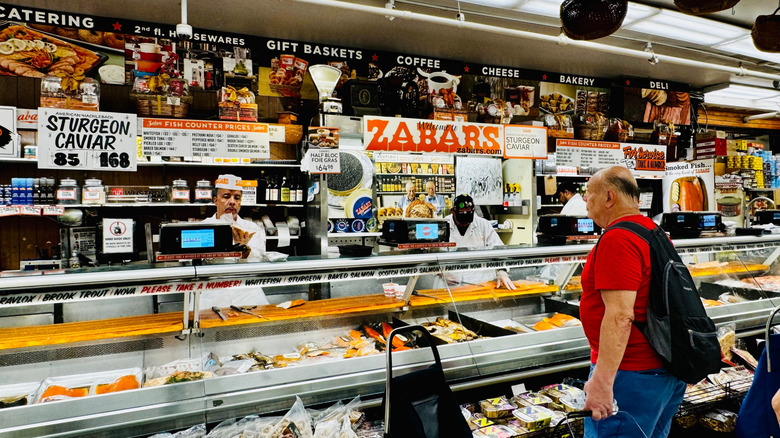 deli counter with customer placing order