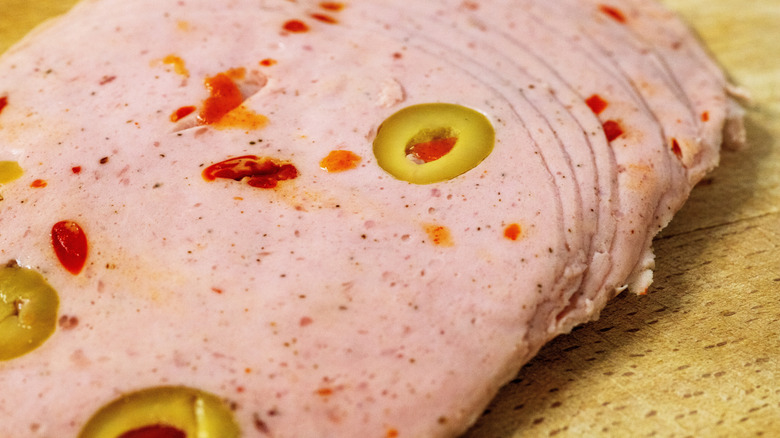Slices of olive loaf on a wooden surface