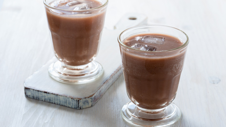 Two chocolate sodas in glasses with ice