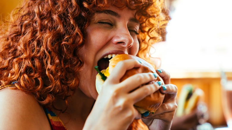 Eating a massive burger