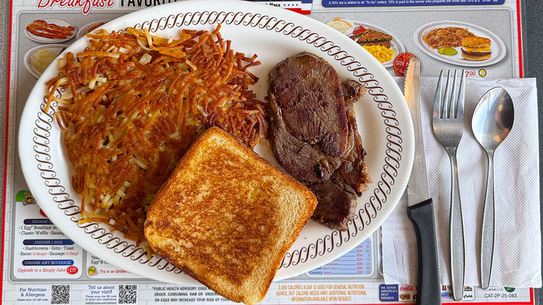 A Waffle House steak meal, including hash browns and toast