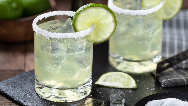 Closeup of a margarita with a salt-rimmed edge and a lime slice