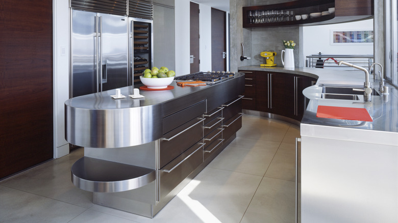 A contemporary kitchen with curved stainless steel counters