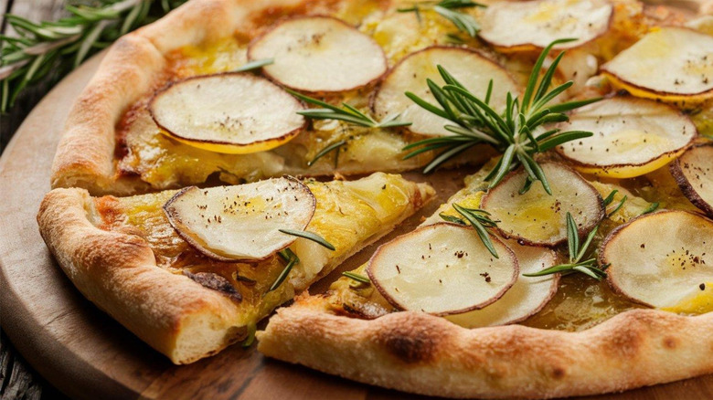 Thinly sliced, crispy potatoes on a cheesy pizza