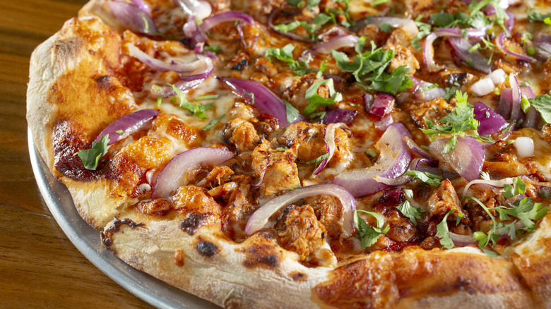 A barbecue chicken pizza with red onions and cilantro