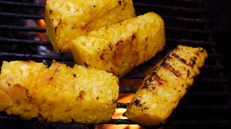 Pineapple wedges getting a char on a grill