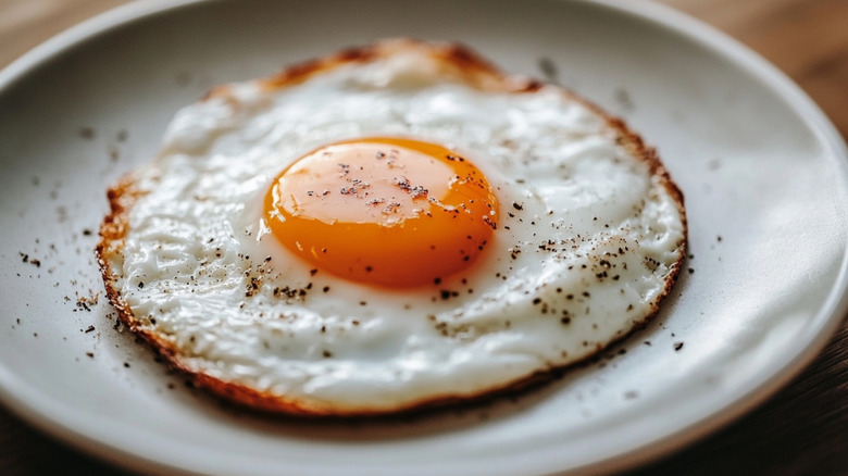 fried egg with caramelized edges on plate