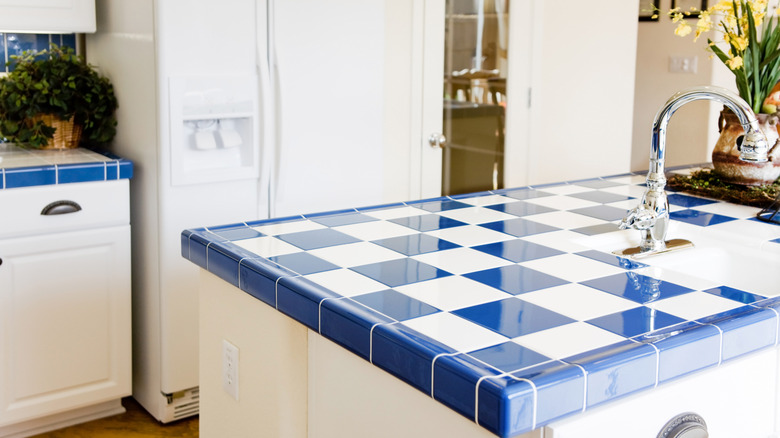 A kitchen with tiled countertops