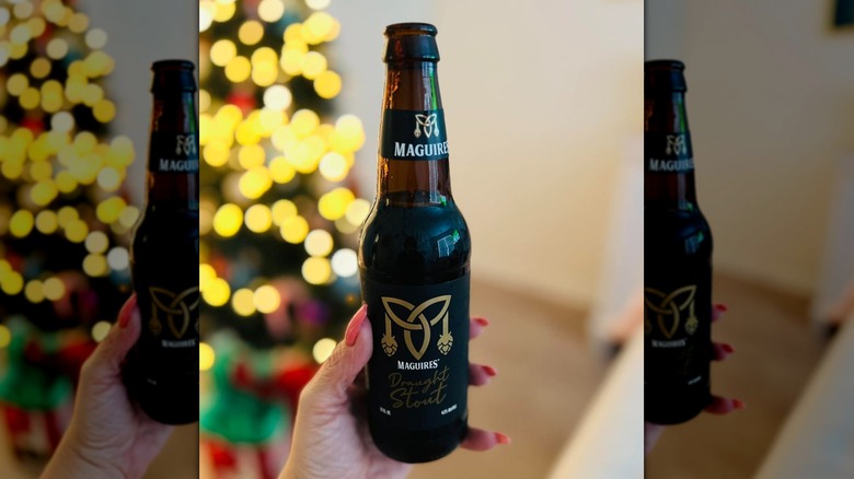 Person holding a  Maguires Draught Stout