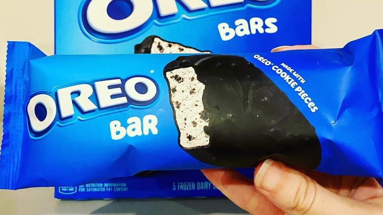 an oreo bar in its wrapper in front of the whole box