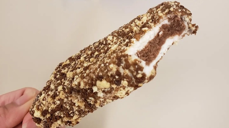 a chocolate crunch bar has a bite taken out of it