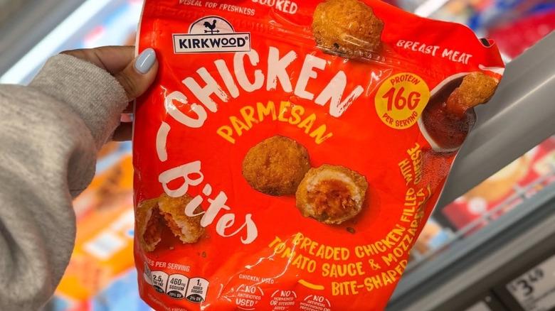 Someone holds up a bag of Kirkwood Chicken Parmesan Bites