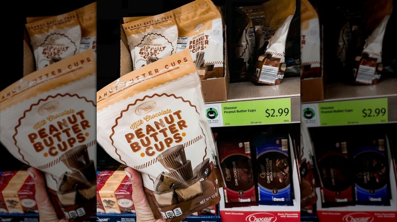 person holding a bag of milk chocolate peanut butter cups