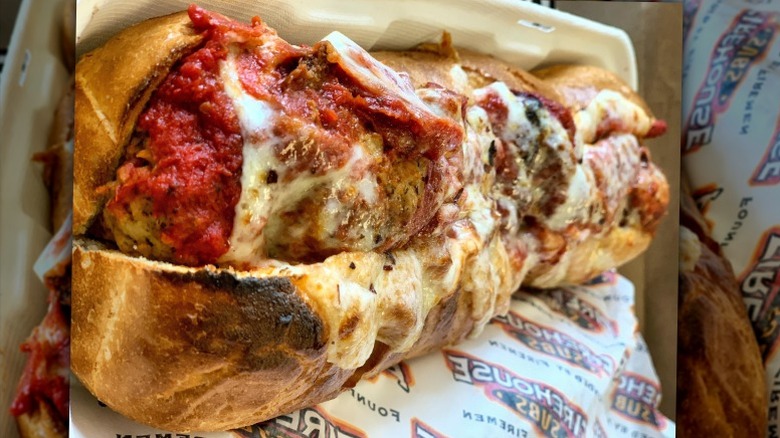 A large meatball sub is sits on a paper wrapper at Firehouse Subs
