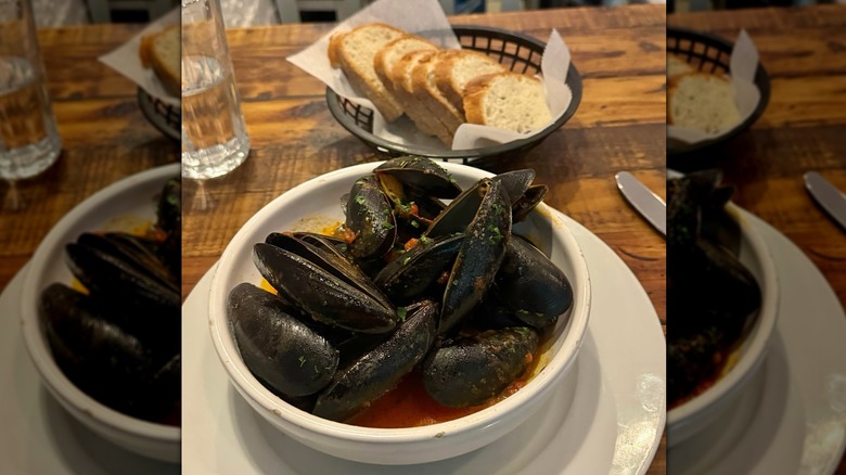 mussels and bread on a wooden table
