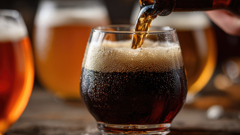 Dark beer being poured into a glass