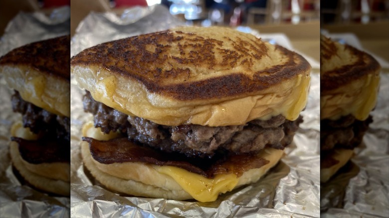 A Grilled Cheese Burger from Five Guys sits on a foil wrapper