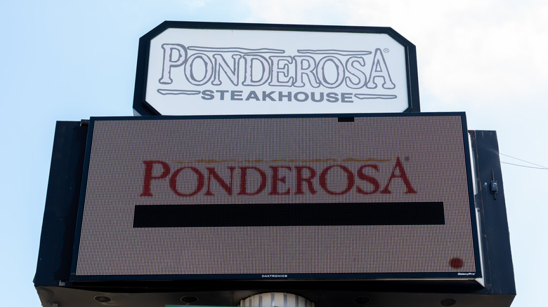 Ponderosa Steakhouse sign against the blue sky.