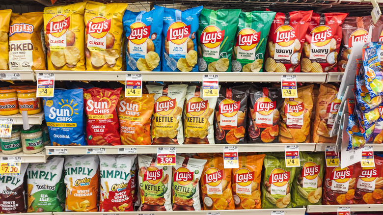 extensively stocked potato chip shelf, mostly with Lay's
