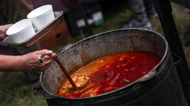 Communal stew being portioned