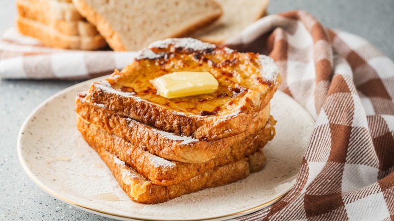 French toast on a white plate with butter
