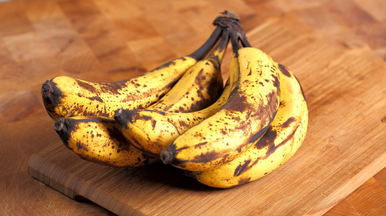 overripe bananas on a cutting board