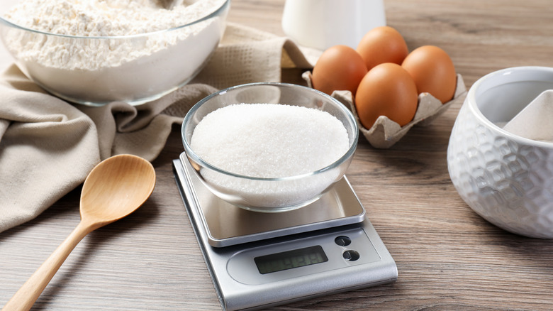 Sugar in a bowl sits on a digital scale