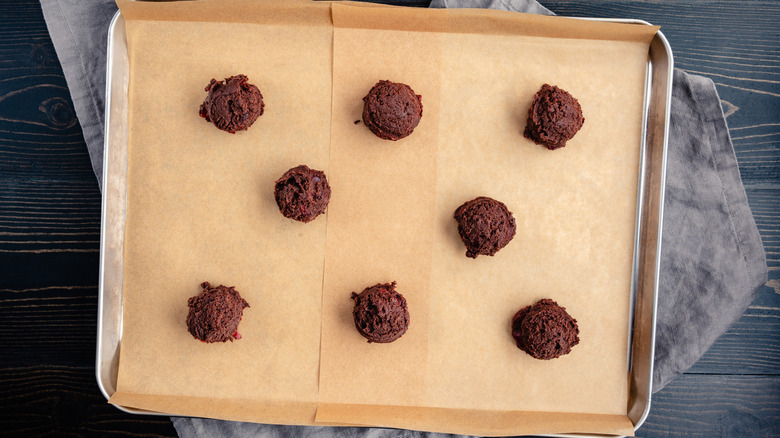 Chocolate cookie dough rests on parchment paper