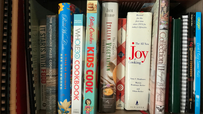 Cookbooks on display on a kitchen shelf