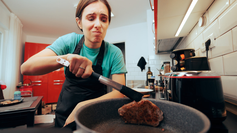 A home cook overcooking fish