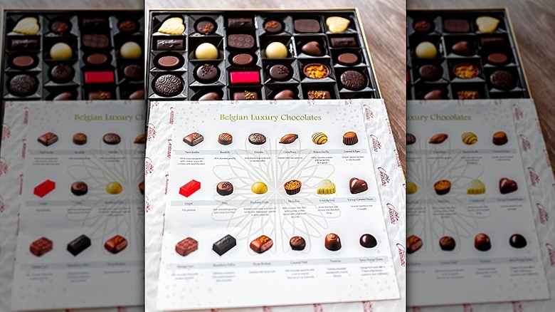 A box of Costco Belgian Luxury Chocolates is open with the candy and candy guide visible