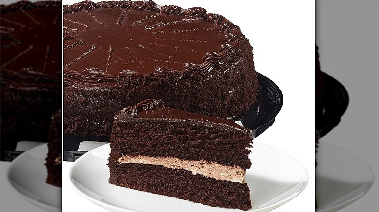 A Costco Chocolate Cake Filled with Chocolate Mousse and a slice of the cake on a white plate