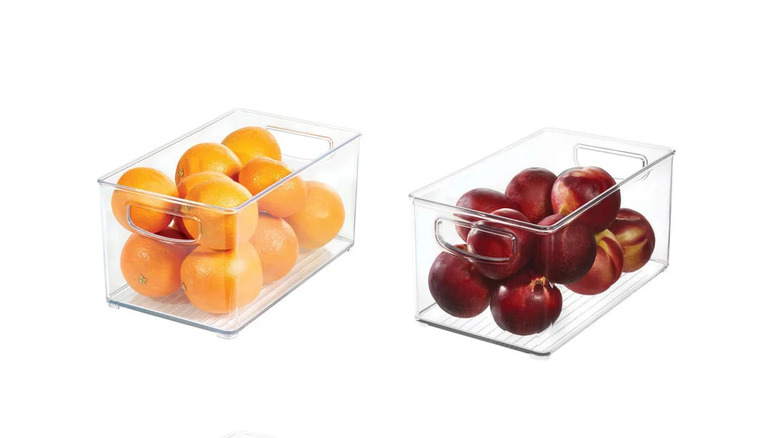 2 clear iDESIGN Linus Plastic Fridge/Pantry Kitchen Organizer Bins with one holding oranges and the other holding apples