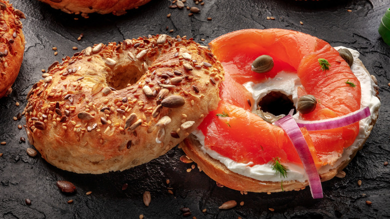 Toasted bagel with lox. capers, and red onions