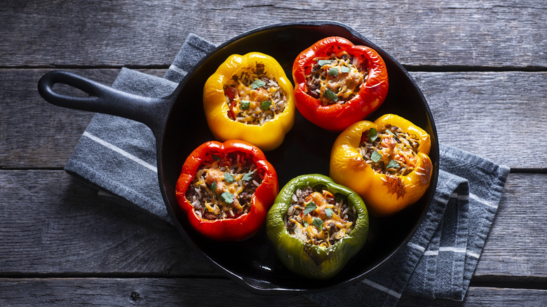 Bell peppers stuffed with beef, herbs, rice, and cheese
