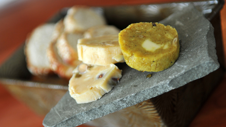 Maple walnut and Curry infused butter on cold slate with freshly baked bread