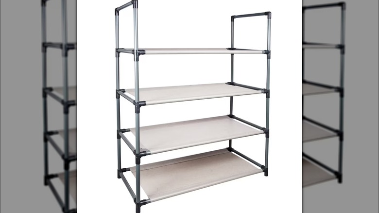 A four-tiered shelf with a plastic piping frame and tan fabric shelving