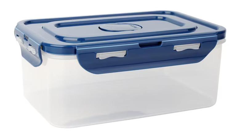 A clear plastic food storage container with a blue clip-top lid