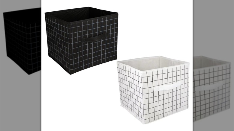 Two fabric collapsible storage cubes are shown, one black and one white