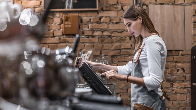 Young woman at point of sale in restaurant