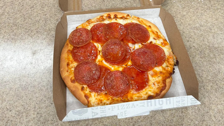 Personal pepperoni pizza from Circle K sitting in a cardboard container.
