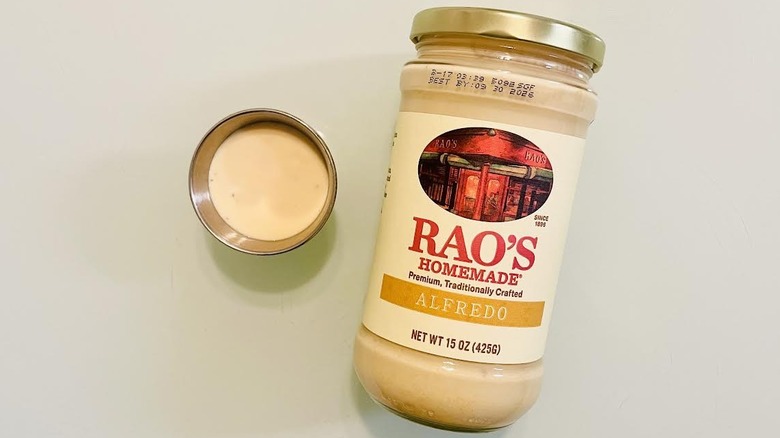 Jar and ramekin of Rao's Homemade Alfredo Sauce