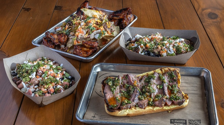 Plates of ribs, brisket, and sandwiches from 4 Rivers Smokehouse