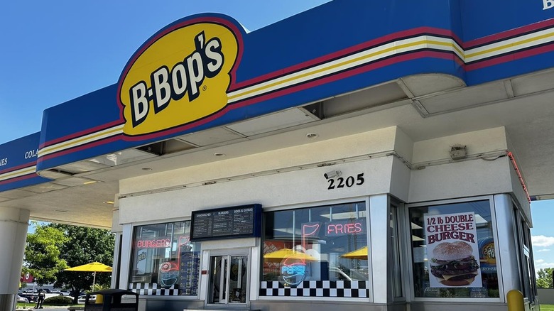 White B-Bop's storefront and white, yellow, black, and red B-Bop's logo on a blue roof