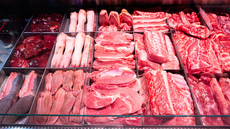 Various cuts of pork fill a butcher's display