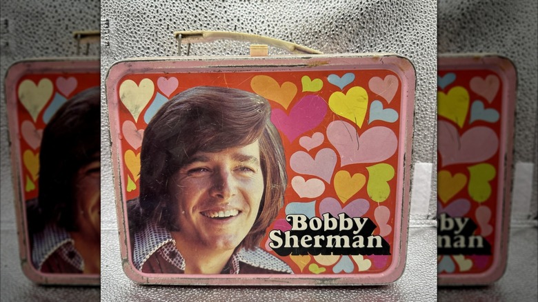 Bobby Sherman on lunch box with hearts against silver background